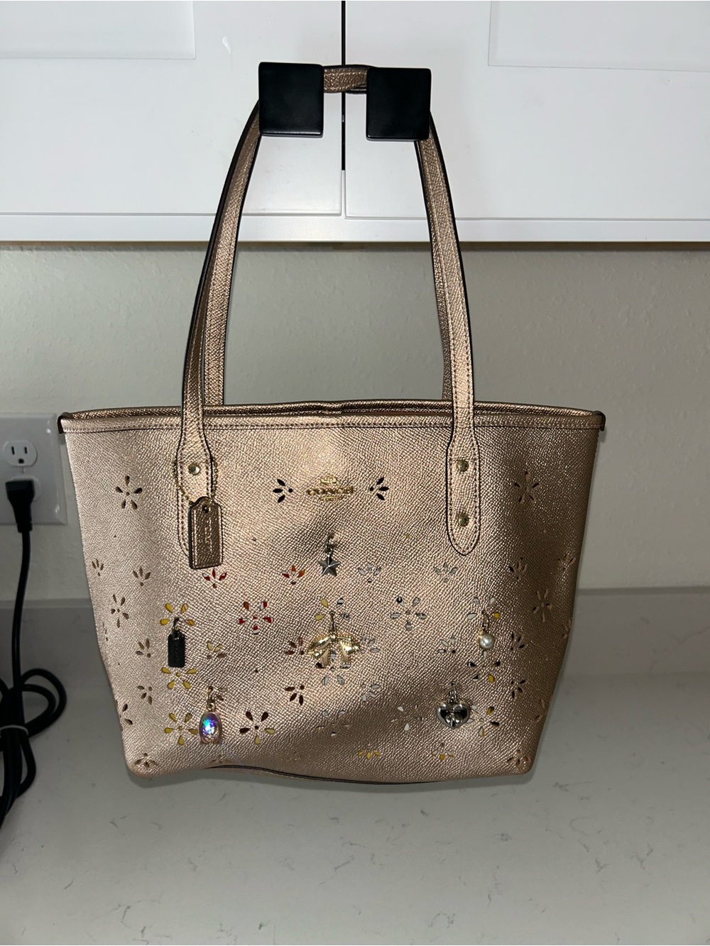 Coach Metallic Rose Gold Floral Cutout Tote with Charms